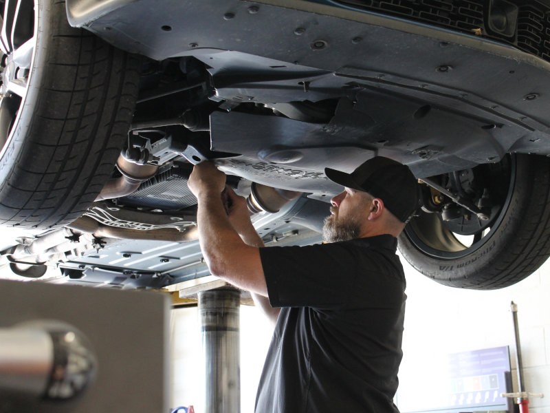 David, owner of NRV Automotive, working under a raised vehicle